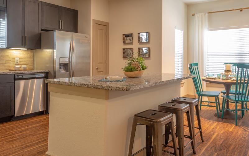 a kitchen with a table and chairs